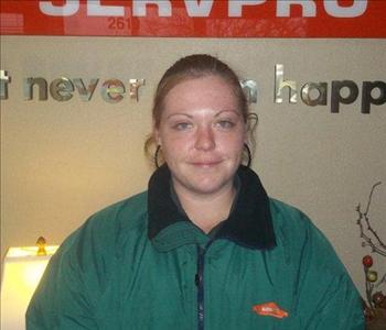 White female in front of SERVPRO sign